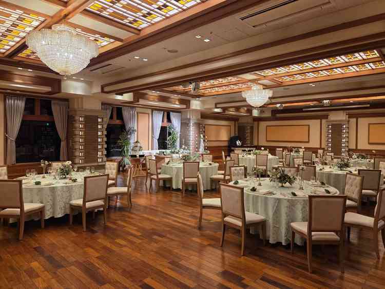 高砂の後ろに庭園が見える披露宴会場で木目が特徴で温かみのある雰囲気でした。60名ほど入ります。