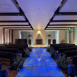 挙式会場は光の演出ができ、席も斜めに設置されているためどこからでも2人をしっかり見ることができる。