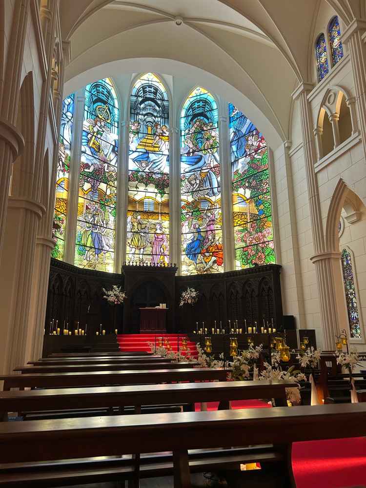 チャペルの写真。天井が高く広々としている。また周囲にはデザインが異なるステンドグラスがたくさん