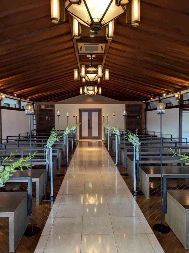 バージンロード。屋形舟をモチーフにしたシャンデリアとお花が素敵。3面ガラス張りで東山を見渡せる。