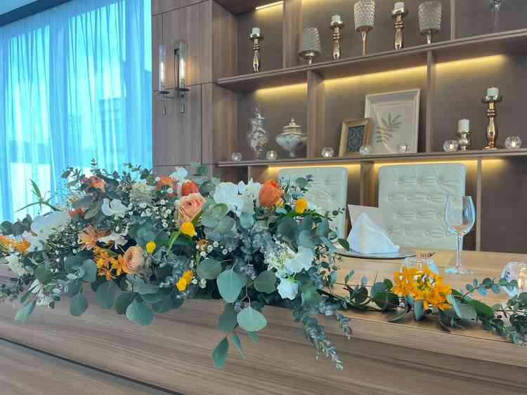 グリーンにオレンジをアクセントにした披露宴会場の様子。ウッド調と合わさり素敵な空間でした。