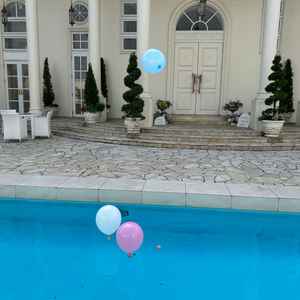 屋外プールに風船をうかべて飛ばすところ