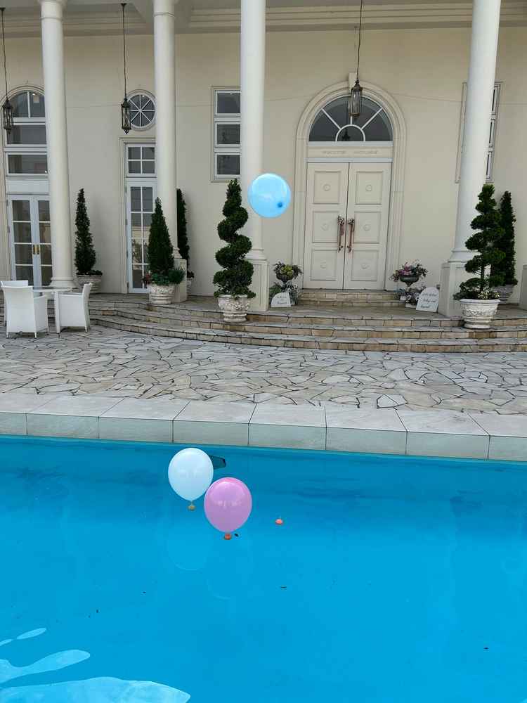 屋外プールに風船をうかべて飛ばすところ