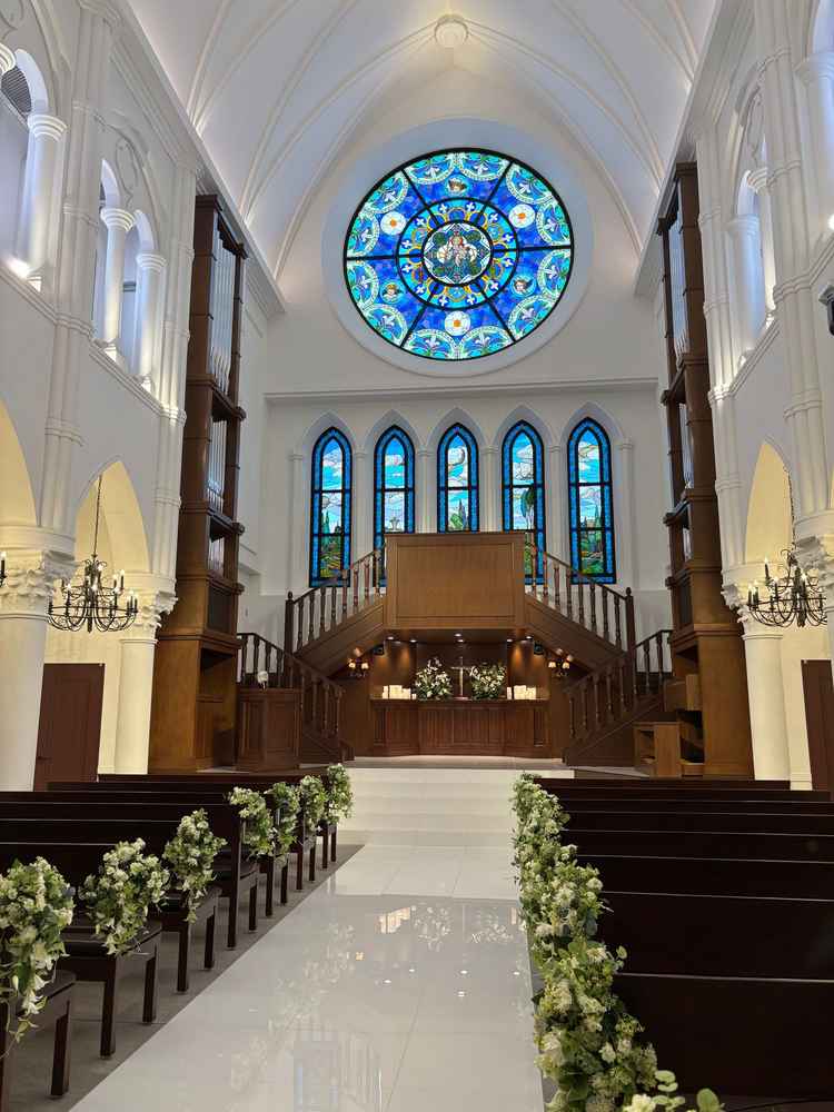 天井が高く広々としたチャペル。大きなステンドグラスが印象的。