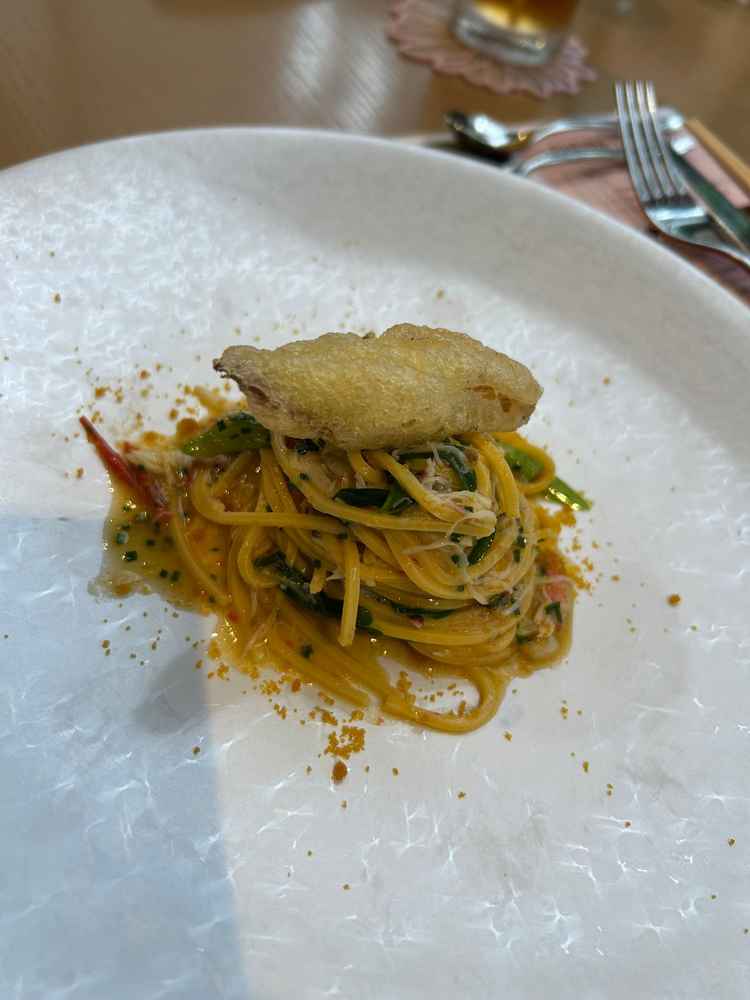 試食のパスタの写真。4.5種類の中から好きな一品を選んだ。ネギが甘くてとてもおいしかった。