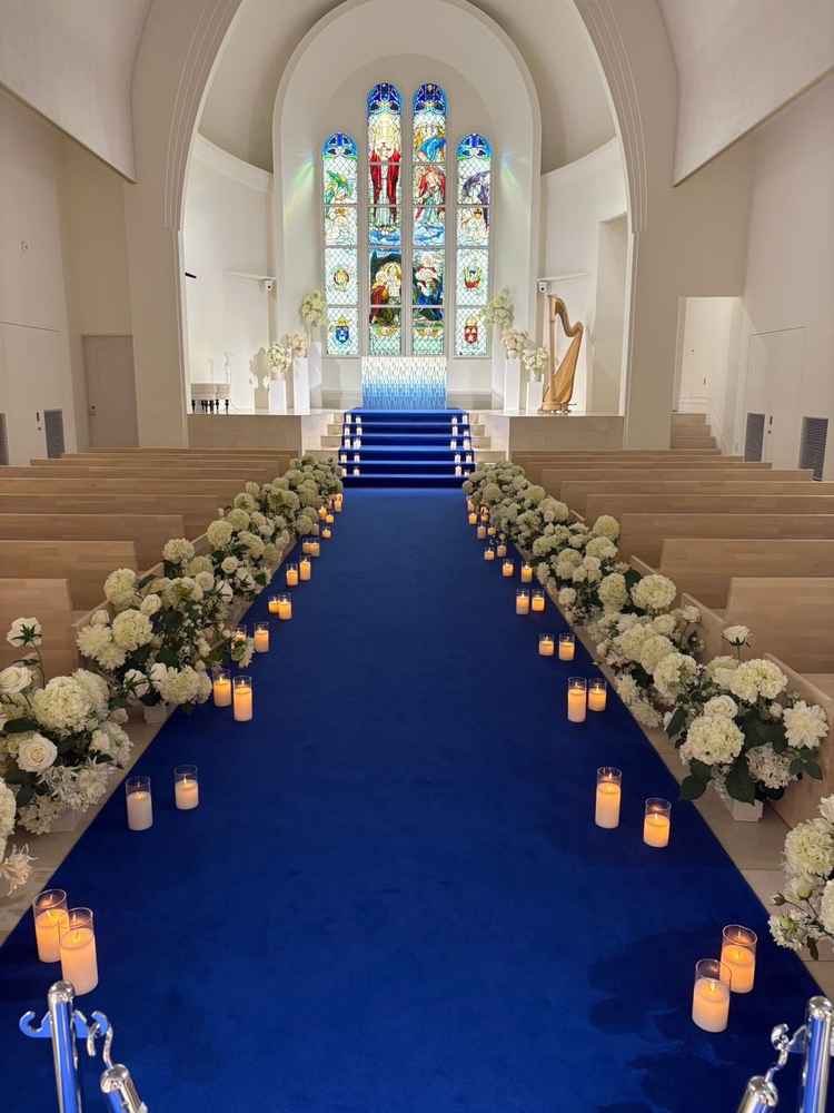 ロイヤルブルーのバージンロードが白いチャペルに映えます。