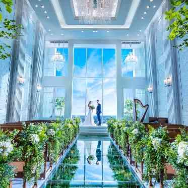 祭壇に立つおふたりの姿が芝生のようなバージンロードに美しく反射され、幻想的