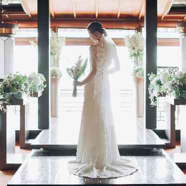 飴色に輝く木目のチャペル。祭壇から射し込む自然光は純白のドレス姿を際立たせる。